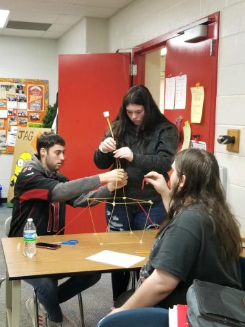 Hunter Coble, Christa Marvin, and Anthony Rivera participate in team building activities during JAG class.