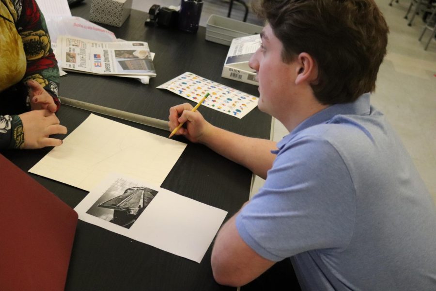 Mrs. Padlo helping Colton Thorpe with his stunning Belair Belair drawing before he starts painting. 