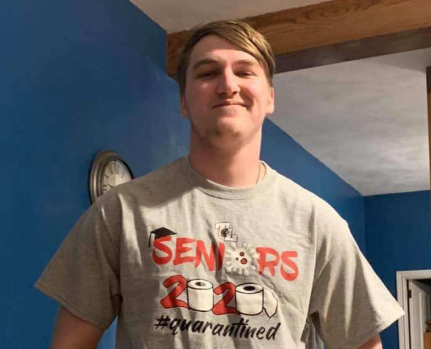 Senior+Wes+Kennington+poses+proudly+wearing+his+new+senior+T-shirt.+These+were+his+thoughts+on+the+surprise.+%E2%80%9CWell+I+wasn%E2%80%99t+home+for+it+sadly%2C+but+coming+home+to+it%2C+and+especially+knowing+they+came+that+far+out+of+town+just+to+do+that%2C+felt+like+such+a+nice+gesture+and+I%E2%80%99m+very+thankful+for+it.%E2%80%9D
