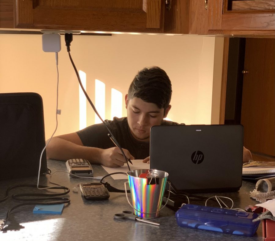 Here Senior Salvador de Leon is working on his Pre-Calculus assignments. With all the things going on in the world, sitting down and continuing to learn at home is something that keeps my mind busy and happy. said de Leon. He is finding a way to continue working on his school work while in the process of moving. Nice job Salvador!