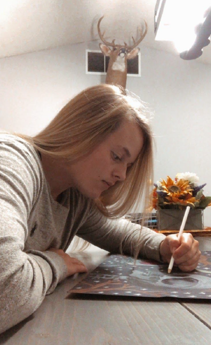 Online school for the win. ​Senior Olivia Crawn is working on an art project. “This art project really helped me stay distracted from the outside world,” said Crawn. Mrs. Padlo is having her Drawing II students work on Surrealism.