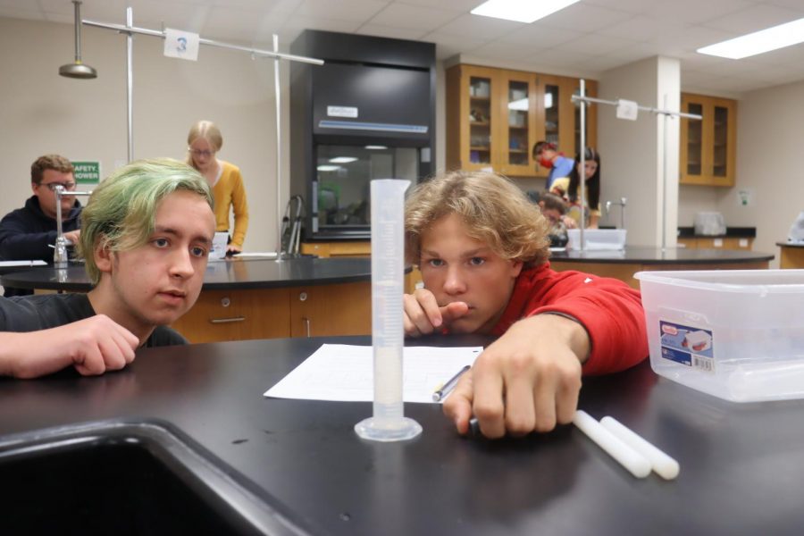 Tristen Wright and Tristen Robertson participate in a lab in Mr. Massuras ICP class. They are learning to measure volume. 