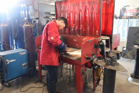 Xavier Ortiz cleans up his welds during Welding I. Students use the grinder to smooth out their welds. Ms. Rosenbaum teaches Welding at Twin Lakes and is also the Welding Club Sponsor.