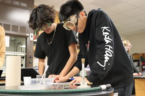 Gael Lopez and Alberto Perez participate in a physical property lab in Mr. Vangs class. 