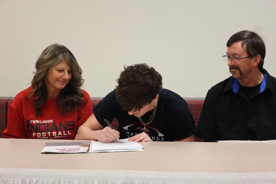 Colin Seymour signs his letter of intent to play football at the University of Indianapolis.