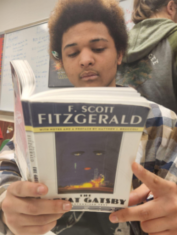 Senior Thai Bryant indulging himself in “The Great Gatsby” by F. Scot Fitzgerald. This
week Mr. Akers plans on covering the history
of jazz in his English 11 class.Mr. Akers sees
it important to cover various genres of
literature to extend the knowledge of his
students.