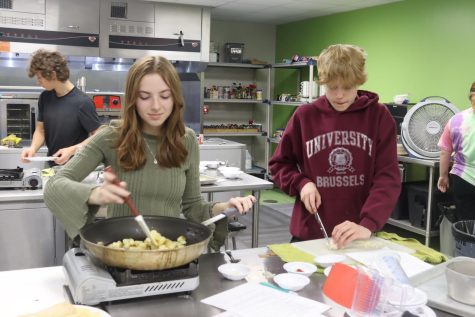 Mattie Roberston and Landon Ramsey cooking up some grub. in Culinary class.