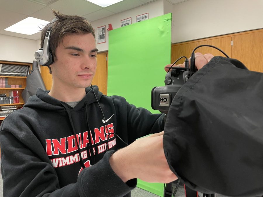 Nolan Roeske 24 is filming in Studio A. He pays special attention to focusing the camera and making sure the audio sounds clean. He said, I love making videos for the business department and providing entertainment for a large audience. This is another successful day for Nolan. 