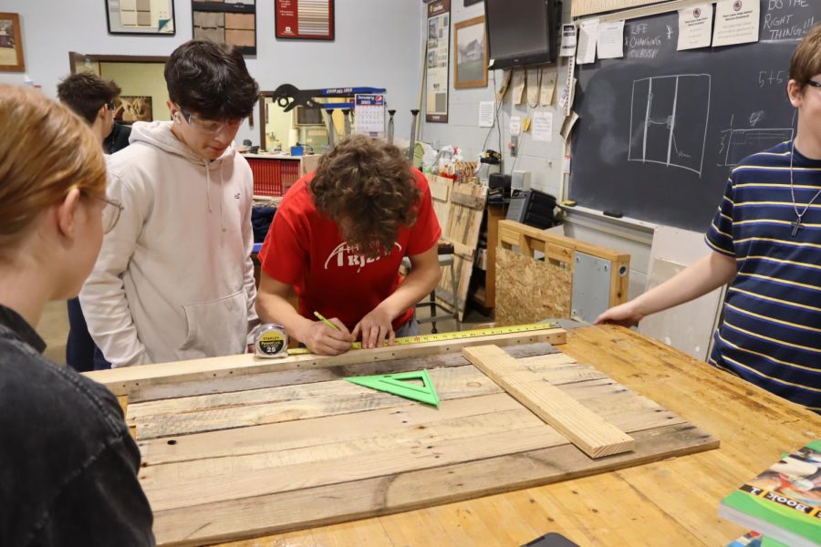 Senior+Kaeden+Dishon+is+in+construction+class+measuring+for+a+project.+I+was+measuring+for+a+project+on+making+a+giant+United+States+flag%2C+said+Kaeden.+Constructions+students+are+making+U.S.+Flags+as+a+fundraiser.