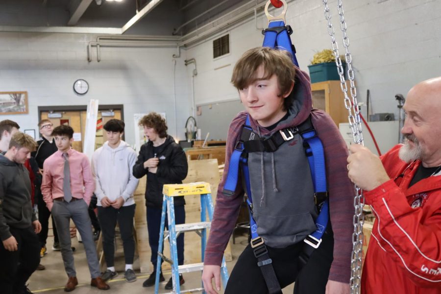 Nolan Evans (9th grade) is hanging around in construction. Nolan Evans says It was fun hanging from the roof on the harness. Construction is an electable class you can take at Twin Lakes at any grade level.