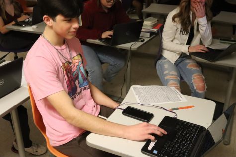 10th Grader, Kaden Simons. Working on homework in Earth, Space Science with Mr. Tinich.  Kaden Simons said, Earth and Space Science is sciency. This is the class where you can learn about Earth and Space all in one. 