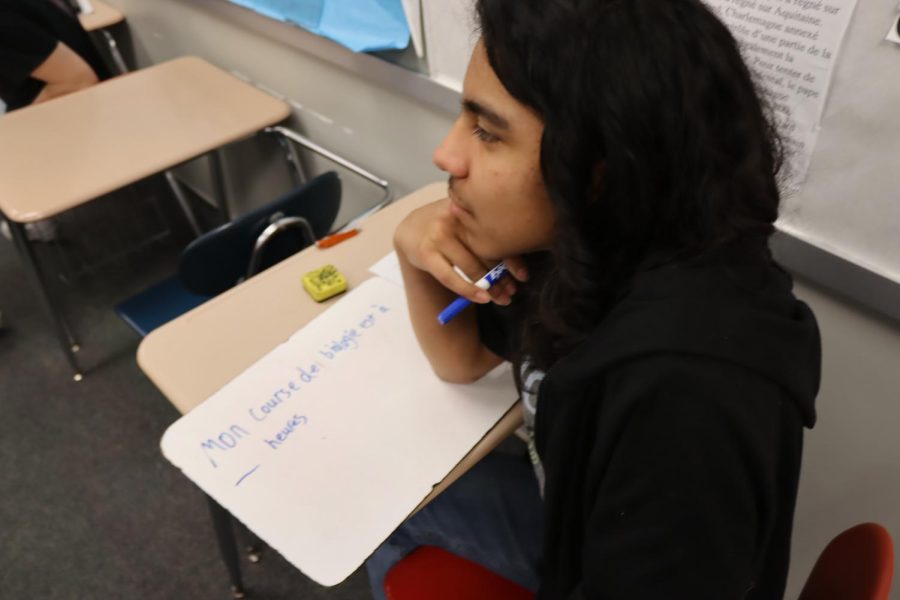 9th Grader, Anthony Mendez, Working hard in French Class with Mr. Schroeder. Anthony Mendez said, We are making sentences in French right now, its hard.